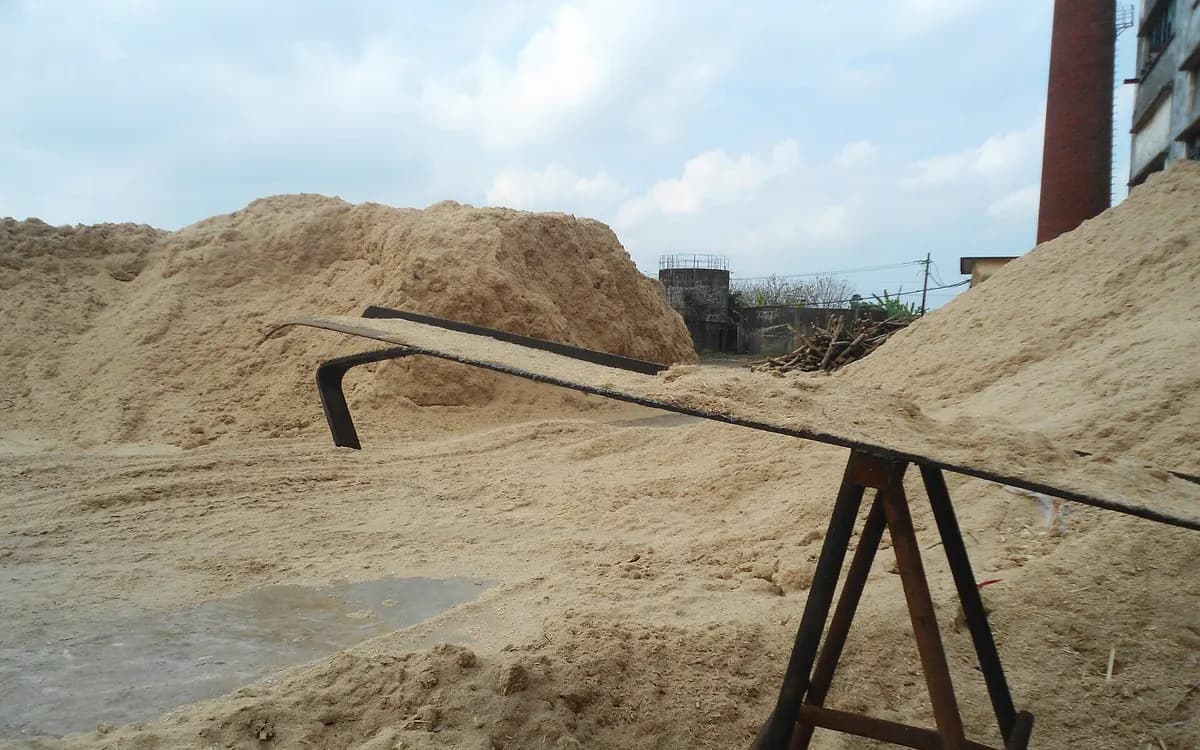 Bagasse in storage beside a loader